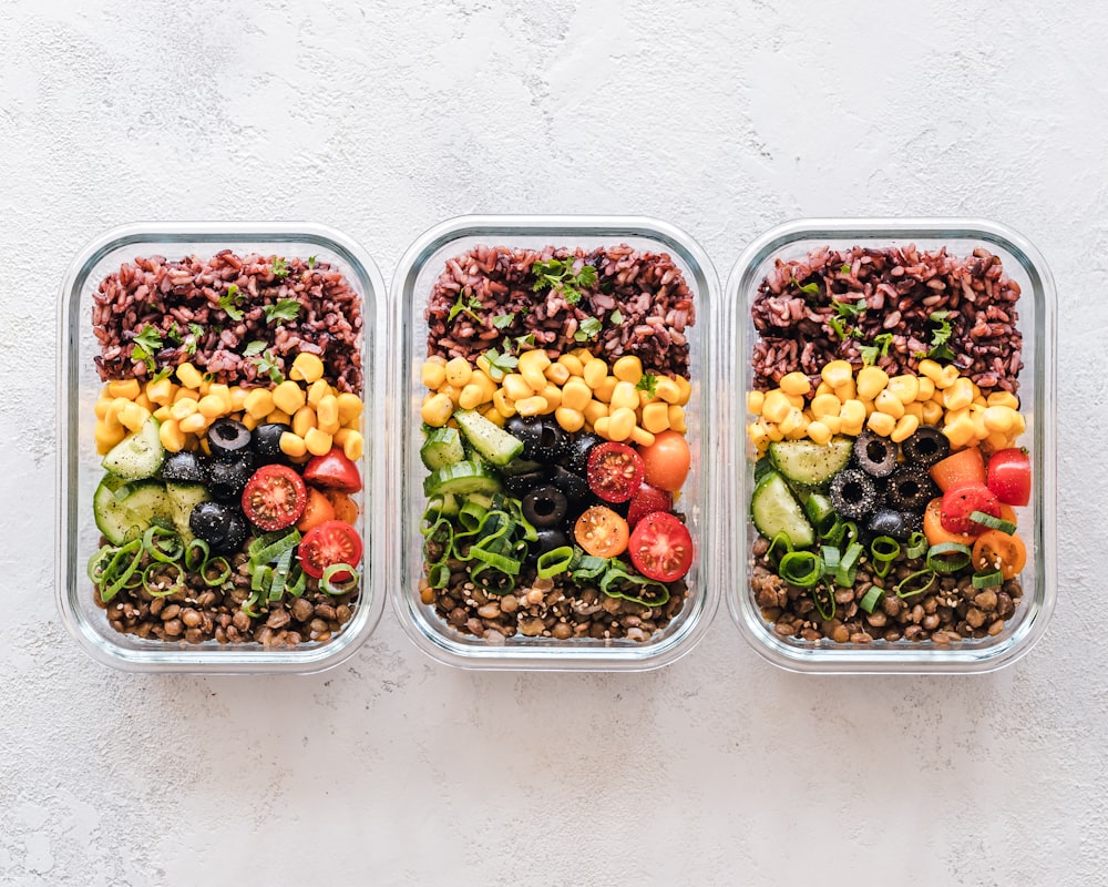 Colourful salad with fresh seasonal vegetables prepared by student